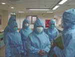 Thumbnail of Hospital workers in Kaohsiung, Taiwan listen to a summary of findings from walkthrough survey and pressurization testing on a severe acute respiratory syndrome patient ward.