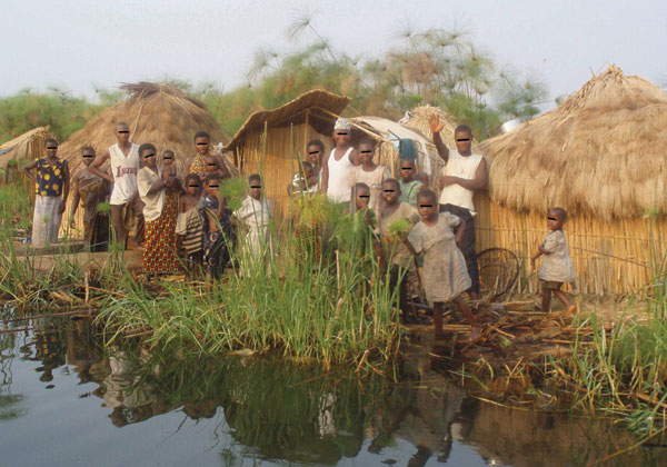 Fishing camp on an island in Lake Upemba, upper Congo River Basin. Fishermen and their families usually spend several weeks every year in camps like this, in which the lake is the only source of water. Because there is no firewood in such areas, campaigns promoting the boiling of water are useless. (Photograph by Didier Bompangue.)