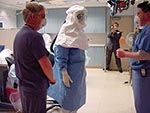 Thumbnail of Healthcare worker wearing powered air-purifying respirators for demonstration. Photos provided by Randy Wax and Laurie Mazrik, Ontario Provincial SARS Biohazard Education Team.