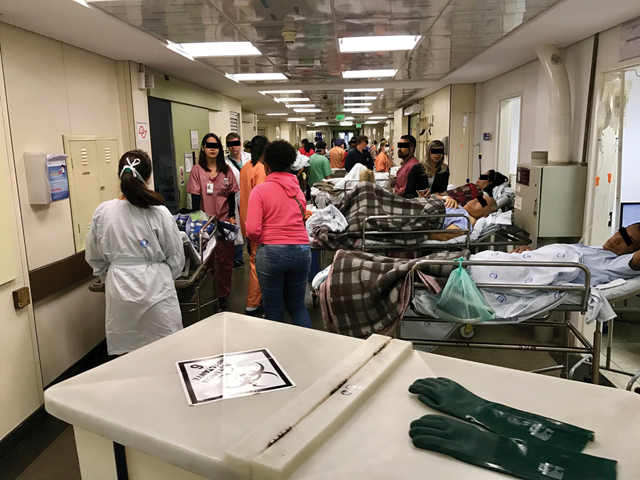 A corridor in the emergency department of Hospital das Clínicas, São Paulo, Brazil, showing patients on stretchers, December 2016.