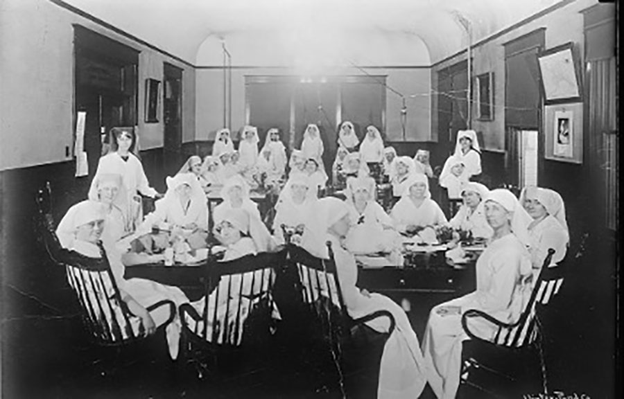 Archival photo of Juneau Chapter of the Red Cross from study of nonpharmaceutical interventions during 1918–1920 influenza pandemic, Alaska, USA. During the pandemic, the Red Cross made cloth mask and distributed to populations in Alaska. However, their reach was limited. Source: Library of Congress (https://www.loc.gov/resource/anrc.06015).