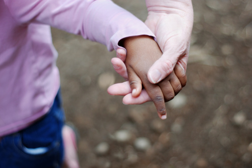 adult and child holding hands