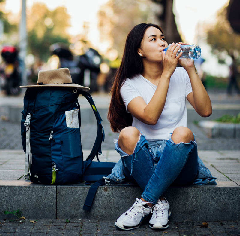 woman drinking bottled water